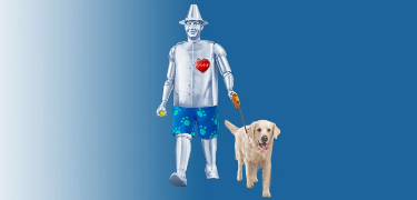 Tin Man walking a golden retriever.